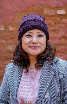 Solid purple wool winter hat with popcorn knit design