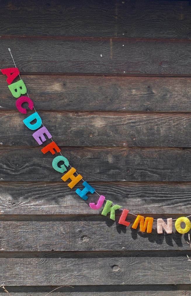 Colorful felt alphabet garland, handmade in Nepal.