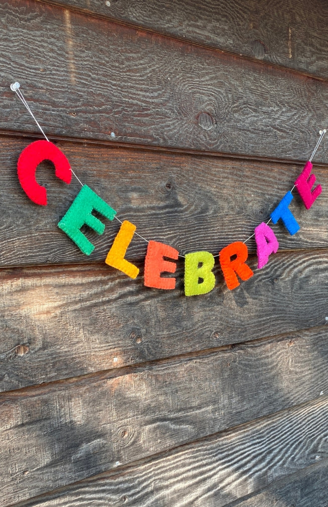 A colorful 'CELEBRATE' felt letter garland. Fair Trade and handmade in Nepal.