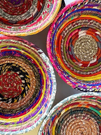 Recycled silk sari scraps are wrapped around cotton rope to create these one-of a kind coiled bowls. Handmade in Nepal.