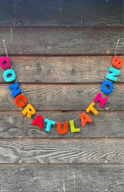 A colorful felt letter garland spelling 'CONGRATULATIONS'. Handmade in Nepal.