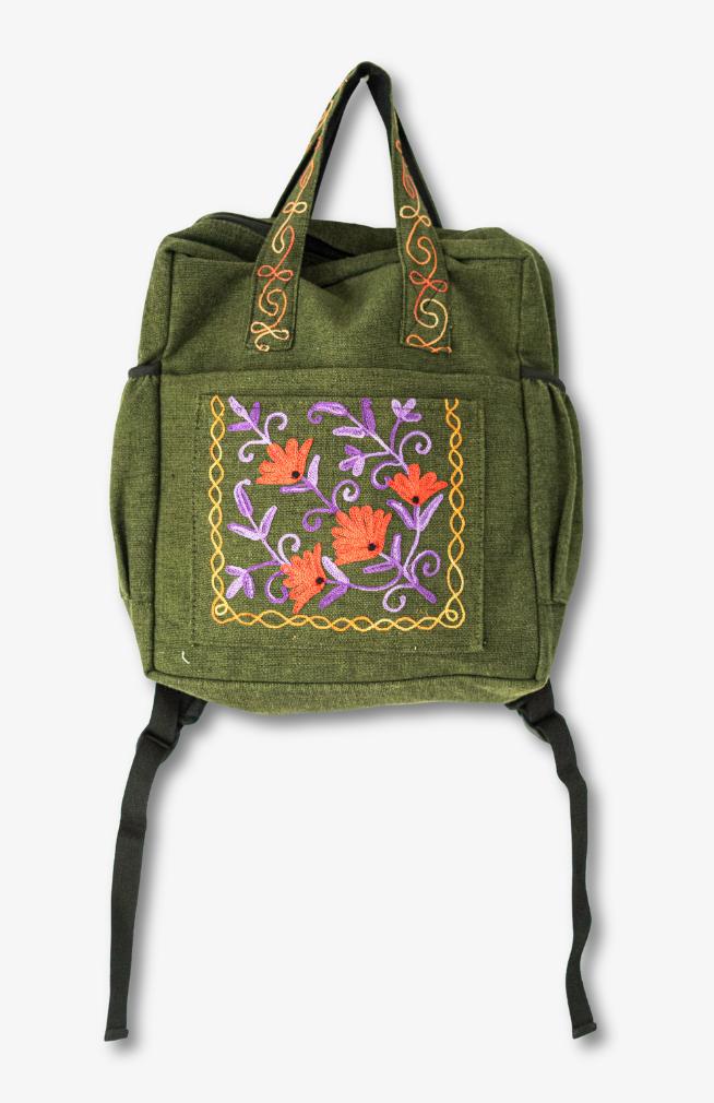 Handmade heavy cotton backpack with floral embroidery and side pockets, made in Nepal.