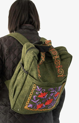 Handmade heavy cotton backpack with floral embroidery and side pockets, made in Nepal.