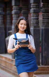 recycled rubber clutch with leather accents and magnetic flap closure