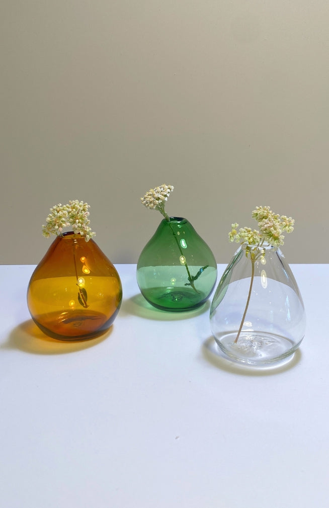 Small teardrop shaped glass bud vase in amber, clear and green. Handmade in Nepal.