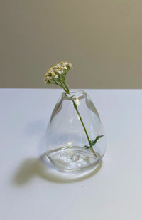 Small teardrop shaped clear glass bud vase. Handmade in Nepal. Fair trade.