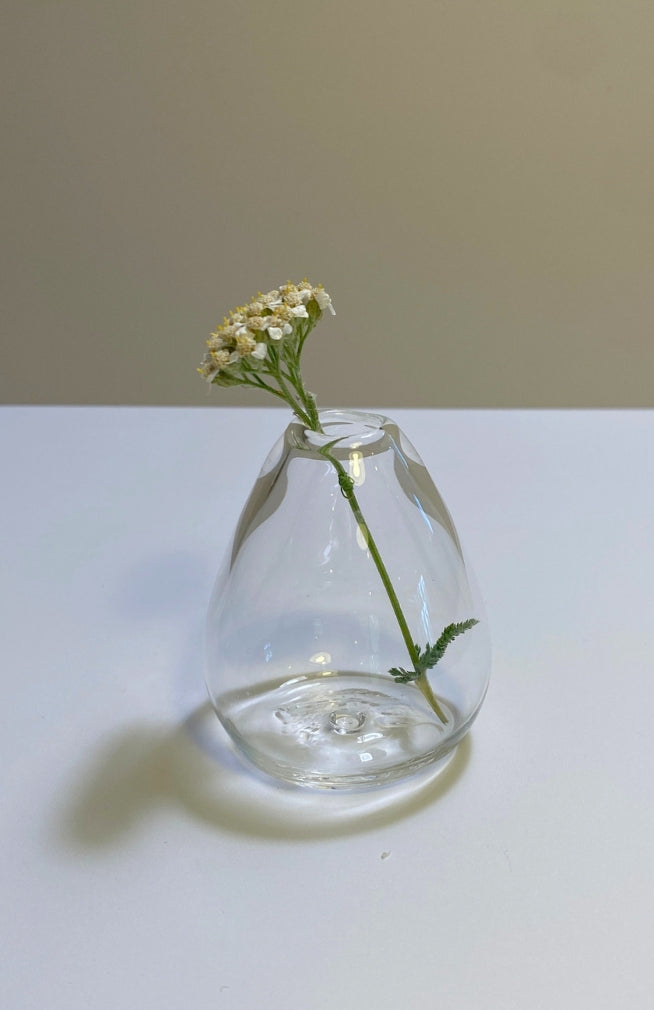 Small teardrop shaped clear glass bud vase. Handmade in Nepal. Fair trade.