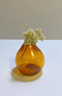 Small teardrop shaped glass bud vase in amber. Handmade in Nepal. Fair trade.