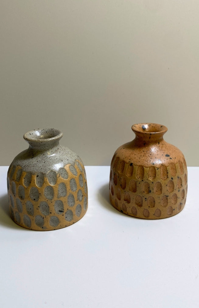 Small handmade ceramic bud vase with textured surface and speckled detail, available in an assortment of colors. Handmade in Nepal.