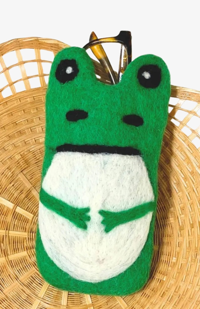 A green and white felted wool frog-shaped eyeglass holder handmade in Nepal
