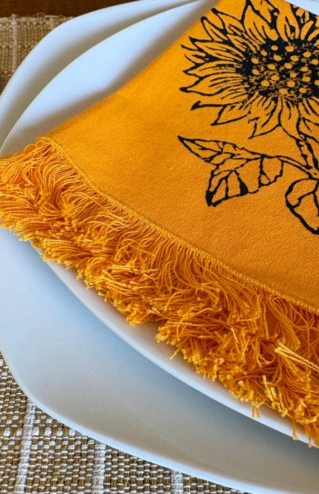 Handmade sunflower print napkin with fringed edges. Fair trade and handmade in Nepal.