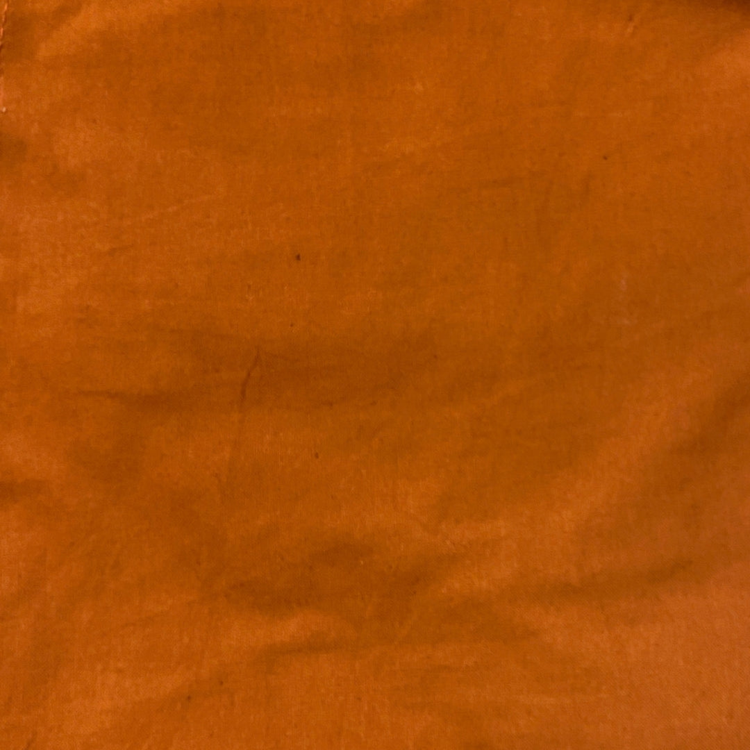 Close up of  handcrafted wide leg pant in the color rust. Handmade by artisans in Nepal.