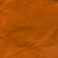 Close up of  handcrafted wide leg pant in the color rust. Handmade by artisans in Nepal.