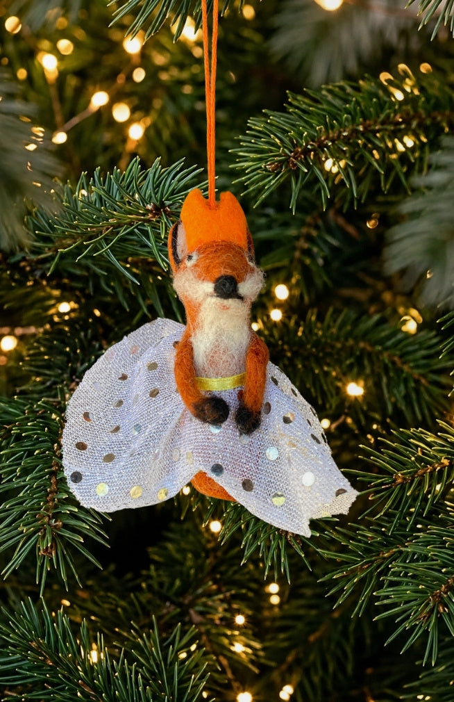 A dancing fox ornament and finger puppet with sparkly skirt and crown. Fair trade and handmade in Nepal.