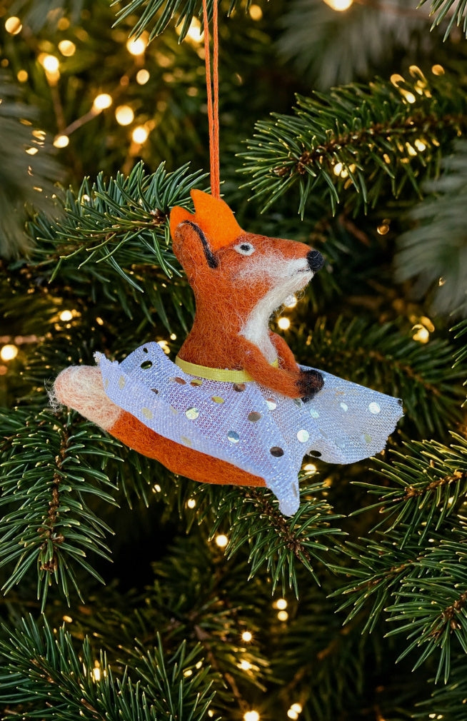 A dancing fox ornament and finger puppet with sparkly skirt and crown. Fair trade and handmade in Nepal.