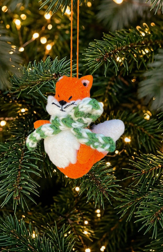 Hand felted orange fox ornament with green and white striped scarf. Handmade in Nepal. Fair trade. 