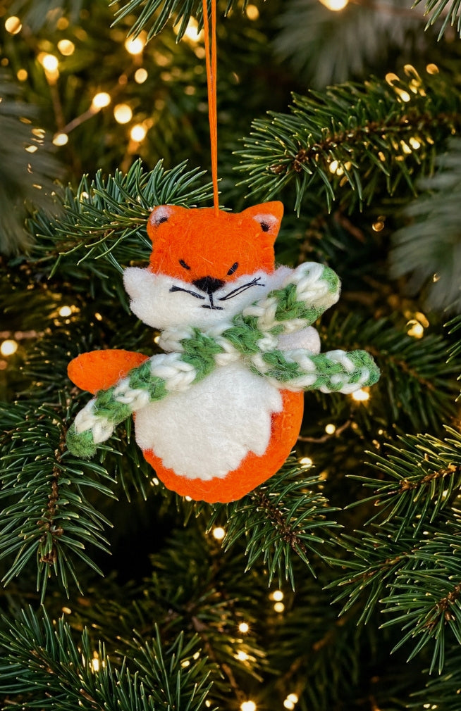 Hand felted orange fox ornament with green and white striped scarf. Handmade in Nepal. Fair trade. 