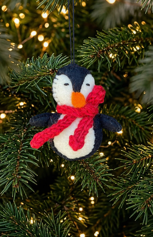 Hand felted penguin ornament with red scarf. Handmade in Nepal. Fair trade.