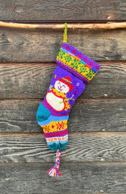 A colorful hand-knit Christmas stocking with a snowman design, handcrafted by artisans in Nepal. Beautiful design, fair trade, unique holiday decor!