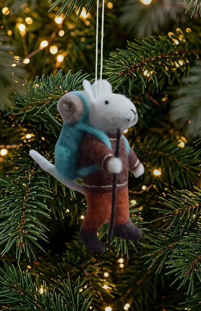 A felted wool mouse Christmas ornament with brown coat, teal-blue backpack and walking stick.