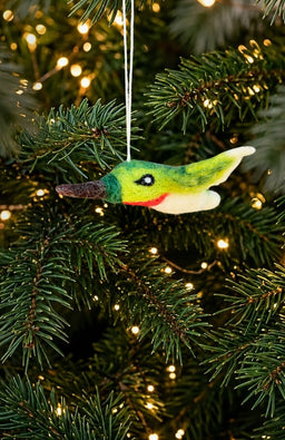 Felted wool hummingbird ornament with green wings and head, ruby throat, white belly, and brown beak. Handmade in Nepal.