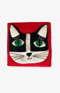 Red Felt Cat Trivet with black and white cat with big whiskers, eyelashes, and green eyes. Handmade by artisans in Nepal.