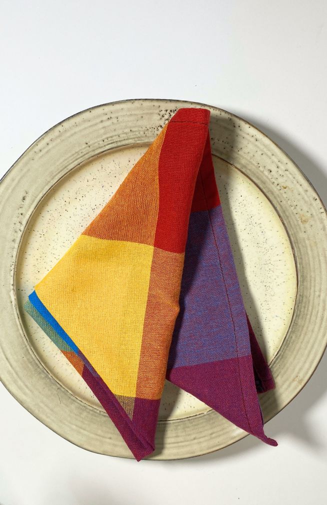 A rainbow/multicolor checked cloth napkin sold as a set of two, quick drying,  handmade in Nepal. 