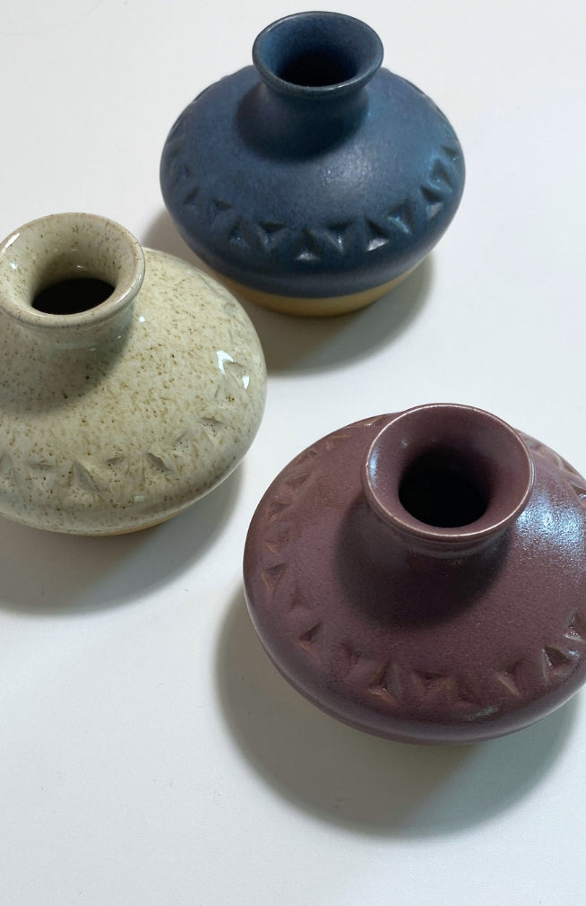 Small handmade ceramic bud vase, handmade in Nepal with a triangle design, available in an assortment of colors.