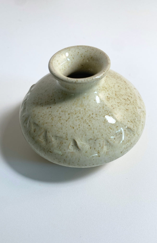 Small handmade ceramic bud vase, handmade in Nepal with a triangle design, available in an assortment of colors.