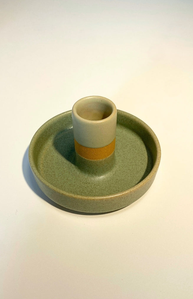 Handmade ceramic candle holder with stripes. Made by artisans in Nepal. Available in an assortment of colors. Fair Trade.