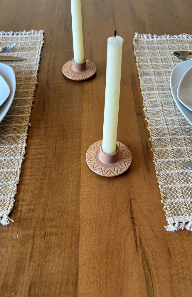 A small round ceramic candle holder with a textured geometric pattern. Handmade in Nepal.