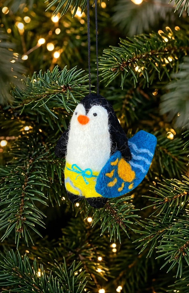 hand felted penguin holding a surf board Christmas tree ornament