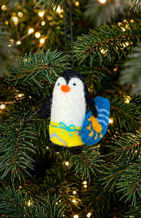 hand felted penguin holding a surf board Christmas tree ornament