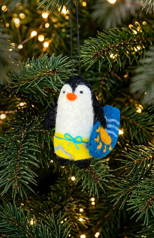 hand felted penguin holding a surf board Christmas tree ornament