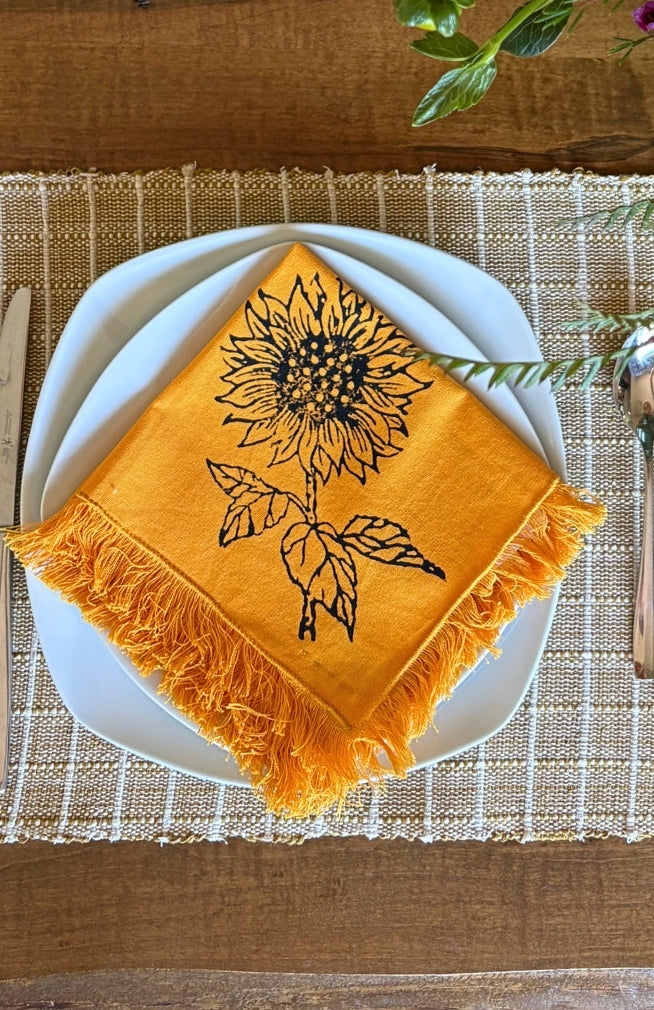 Handmade sunflower print napkin with fringed edges. Fair trade and handmade in Nepal.