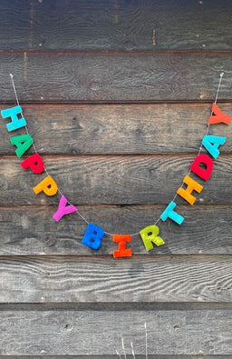 A colorful 'HAPPY BIRTHDAY' felt letter garland. Fair trade and handmade in Nepal.