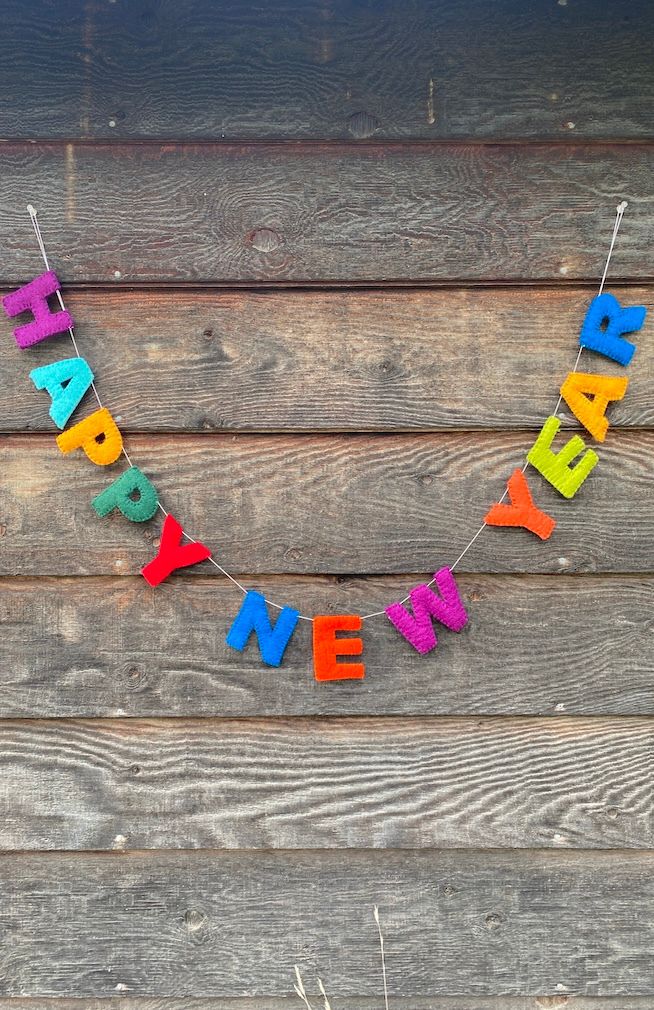 A colorful 'HAPPY NEW YEAR' felt banner garland, hand made in Nepal, certified fair trade