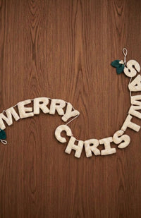Hand made "MERRY CHRISTMAS" garland with white letters and two overlapping green leaves with white berries on each end