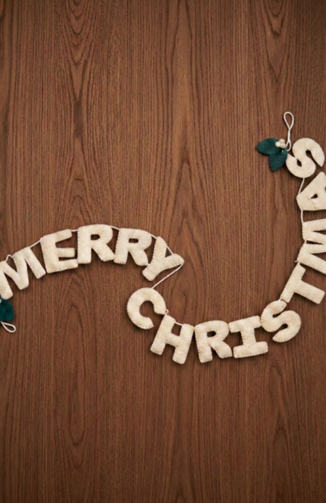 Hand made "MERRY CHRISTMAS" garland with white letters and two overlapping green leaves with white berries on each end