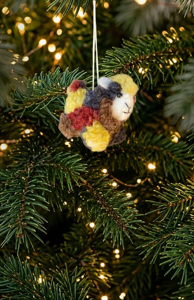A set of 6 colorful felt sheep ornaments. Handmade in Nepal from 100% New Zealand wool. Fair trade.