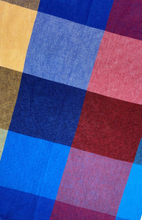 Close up image of red, blue, and yellow checked cloth napkin sold as a set of two, quick drying, handmade in Nepal. 