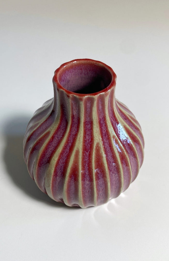 Plum ceramic bud vase with ribbed detail. Handmade in Nepal.