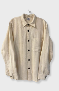 A fair trade, cream-colored textured long-sleeve button-up shirt with a collar and chest pocket