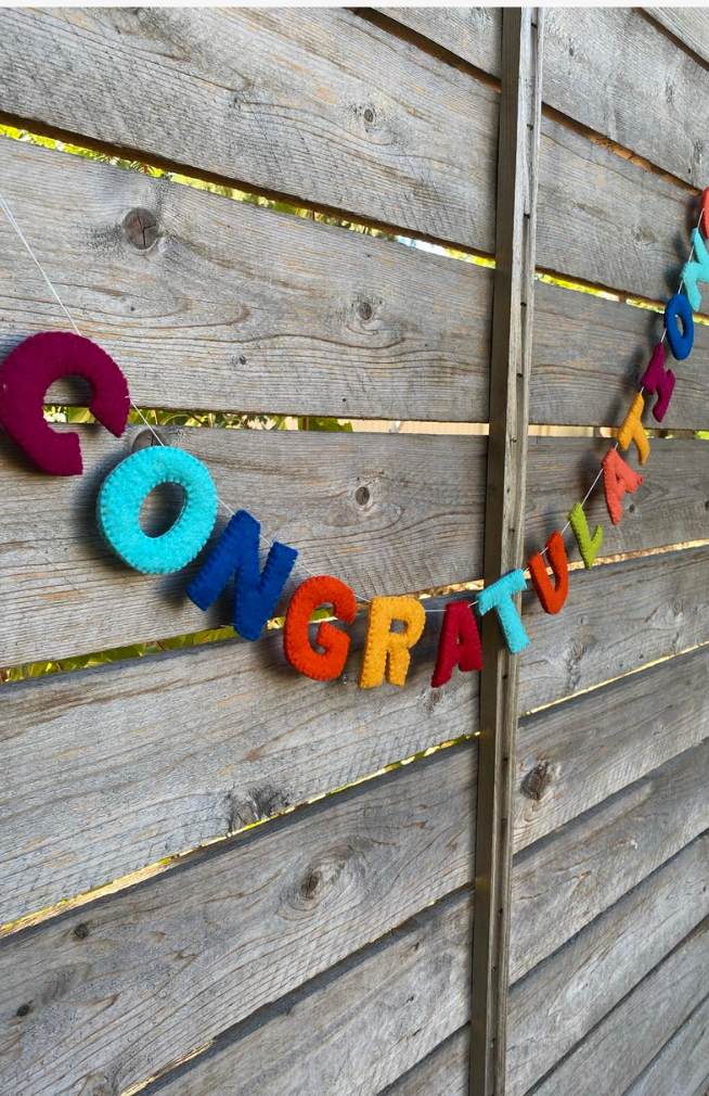 A colorful felt letter garland spelling 'CONGRATULATIONS'. Handmade in Nepal.