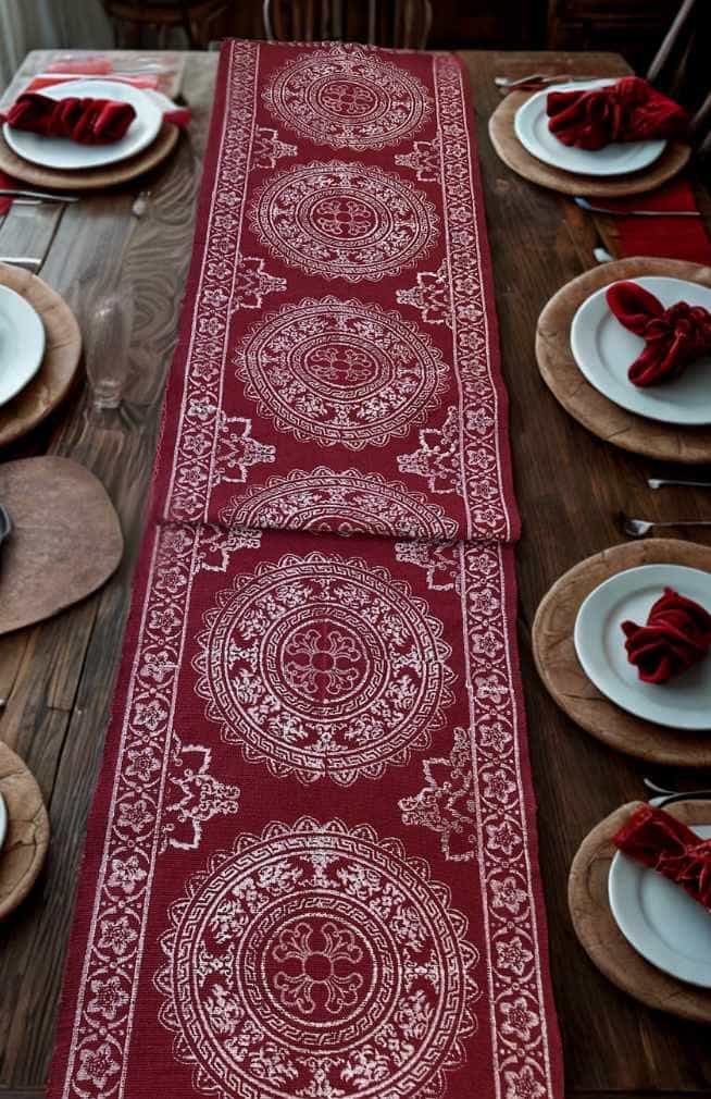 red cotton table runner with white blockprinted design