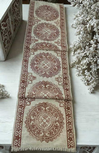white cotton table runner with red blockprinted mandala design