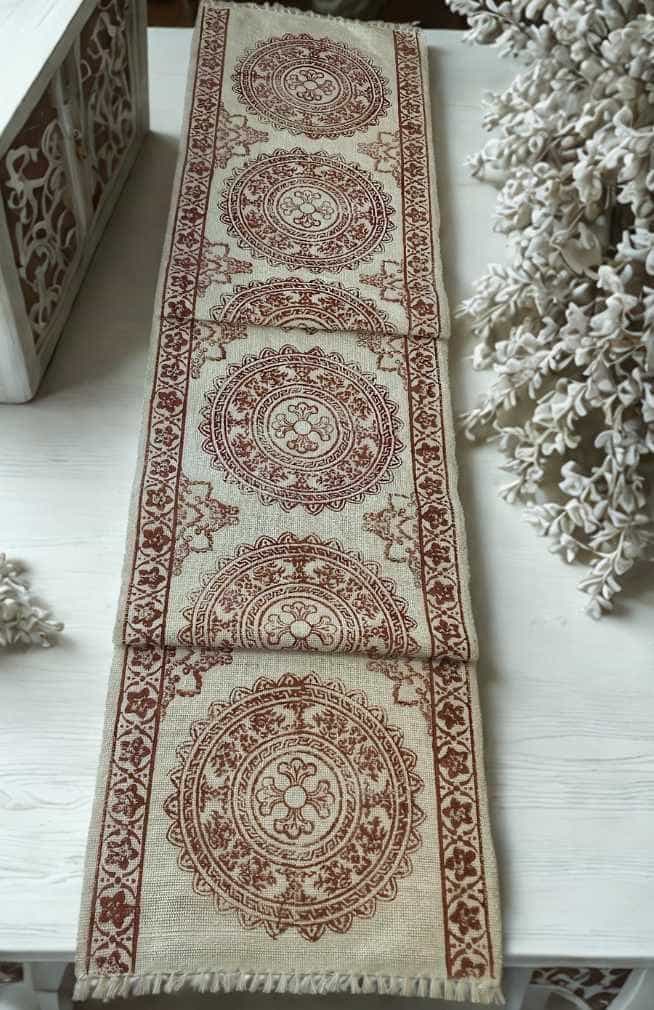 white cotton table runner with red blockprinted mandala design