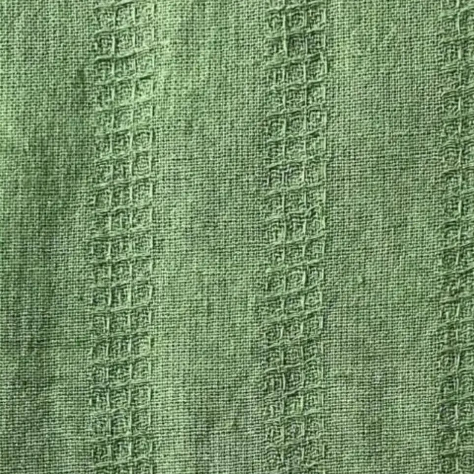 close up of green textured cotton