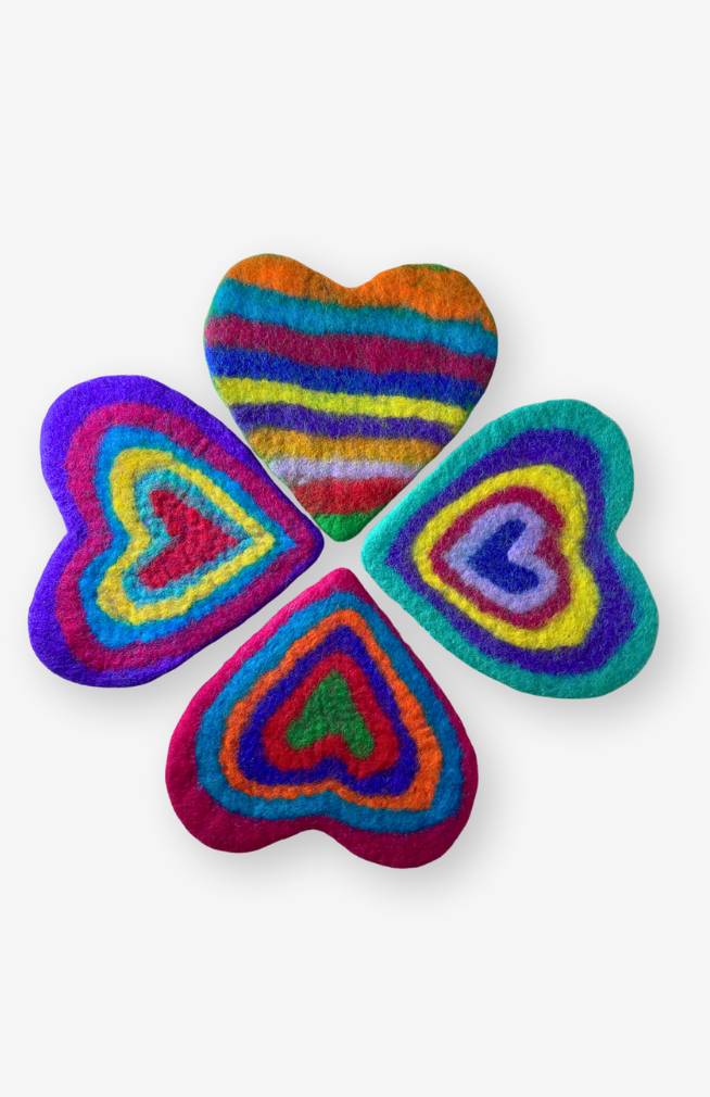 Four assorted colorful heart shaped trivets made from felted wool