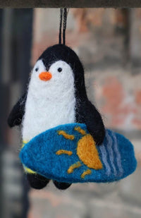 hand felted penguin holding a surf board Christmas tree ornament